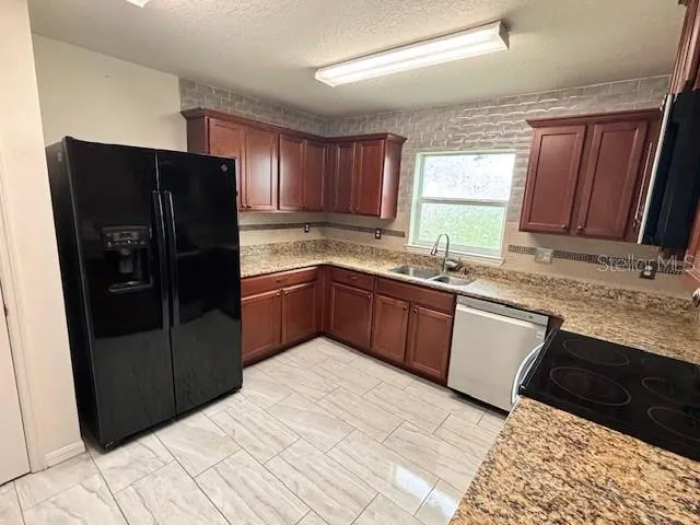 a kitchen with a sink stove and refrigerator