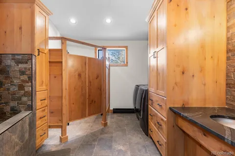 a bathroom with a double vanity sink and a mirror