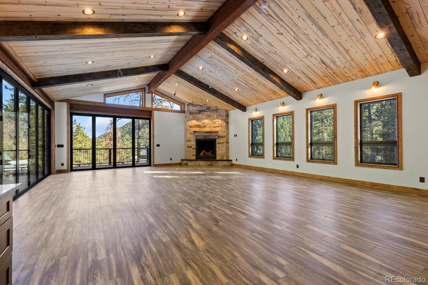 10013 McKinney Road Littleton, CO 80127 - Photo 28 of 50 a view of an empty room with wooden floor and a window