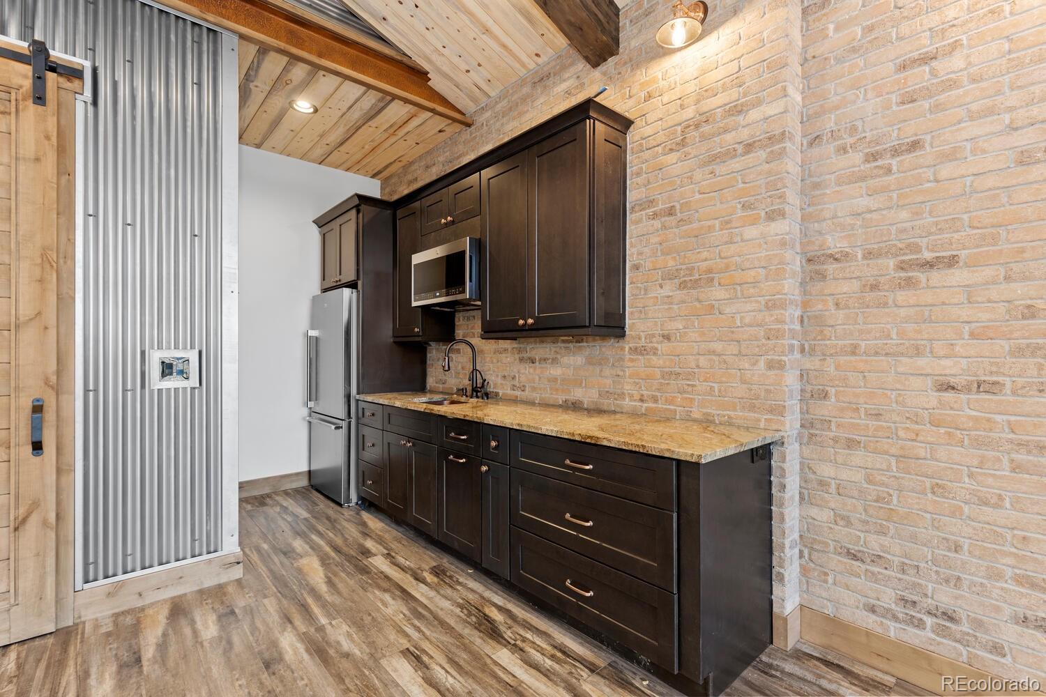 10013 McKinney Road Littleton, CO 80127 - Photo 32 of 50 a spacious bathroom with a granite countertop sink a mirror and shower