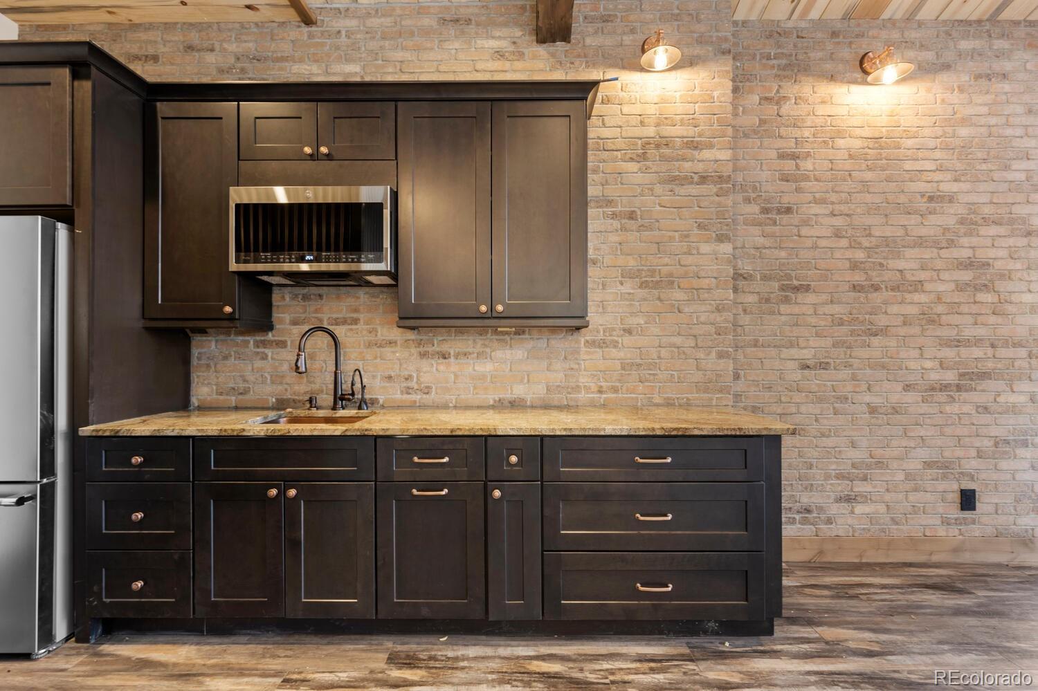 10013 McKinney Road Littleton, CO 80127 - Photo 33 of 50 a kitchen with a sink and a microwave