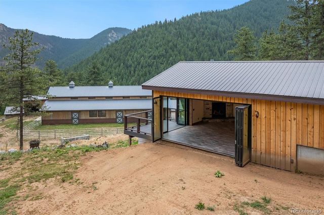 a view of a house with pool and a yard