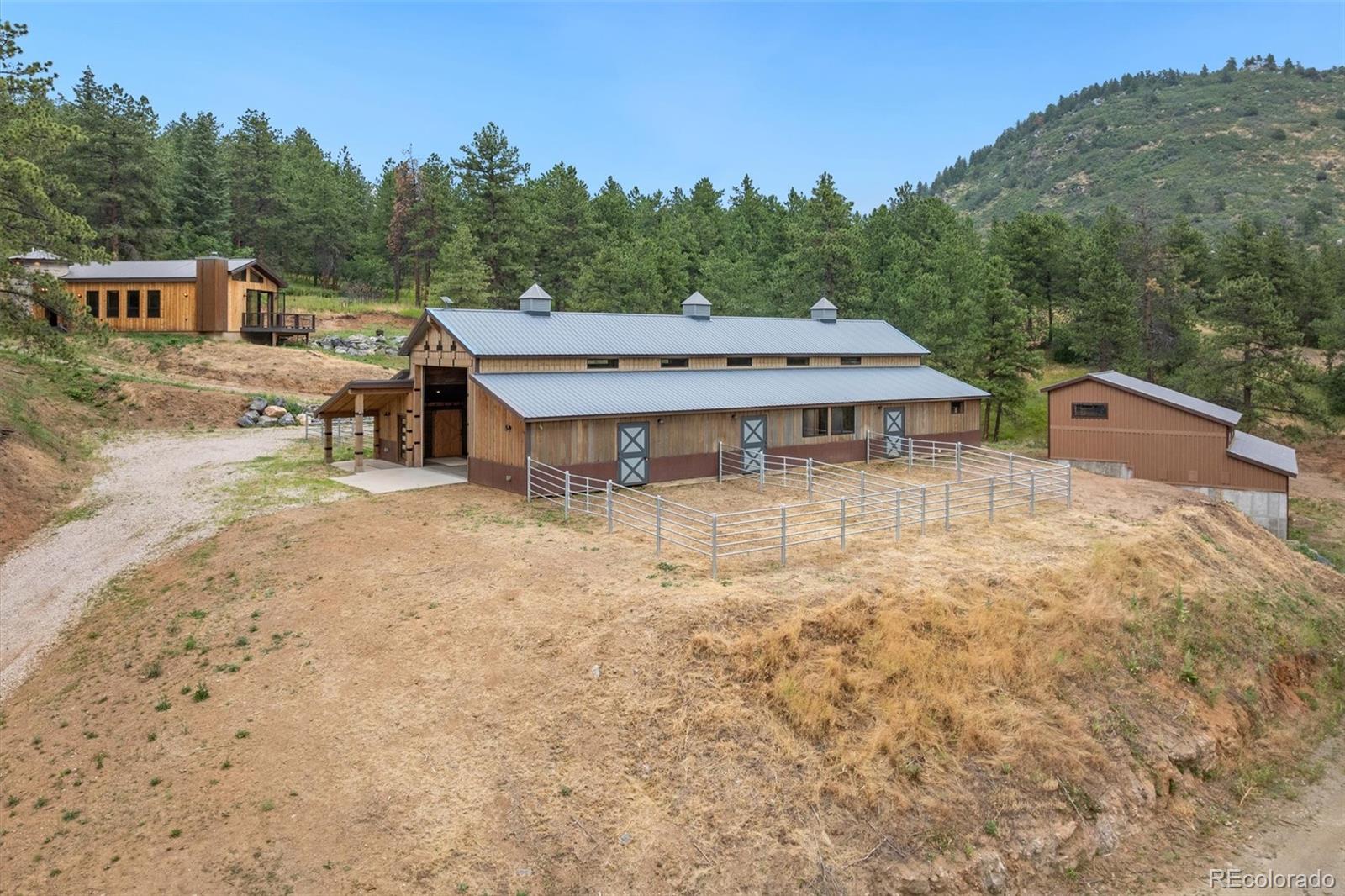 10013 McKinney Road Littleton, CO 80127 - Photo 39 of 50 a view of a house with a yard and sitting area
