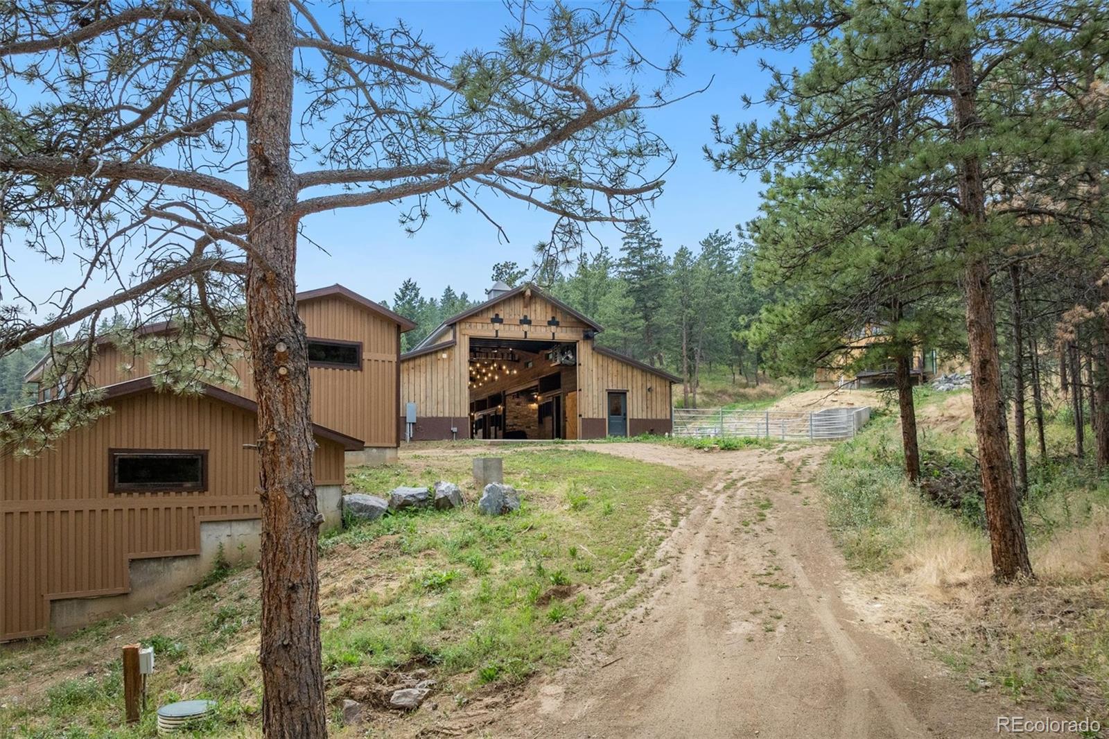 10013 McKinney Road Littleton, CO 80127 - Photo 42 of 50 a yellow house with trees in front of it