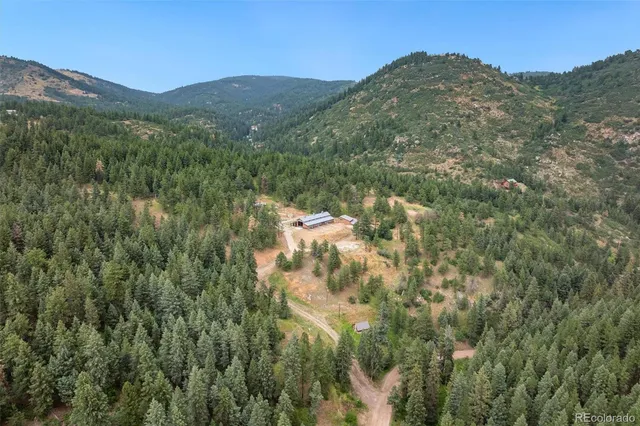 a view of a mountain in the distance in a field