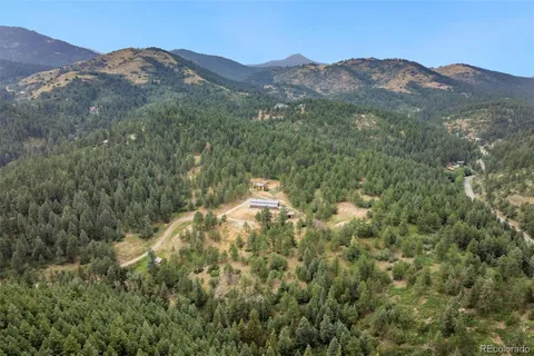 a view of a mountain in the distance in a field