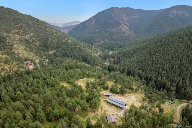 a view of a lush green hillside and a building