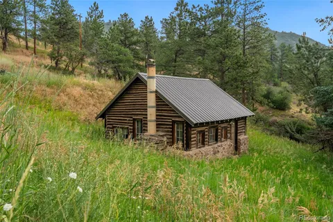 a view of a house with pool and trees all around