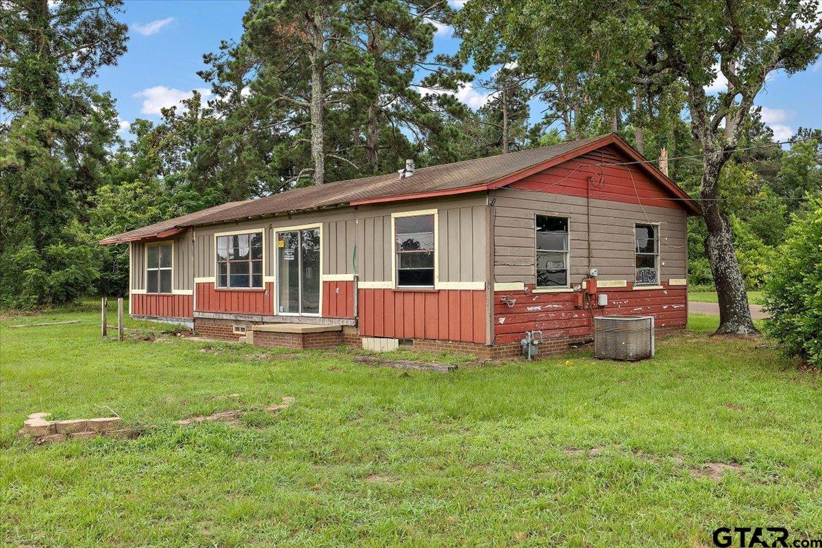 1535 North Dickinson Drive Rusk, TX 75785 - Photo 9 of 18 a view of a house with a yard and deck