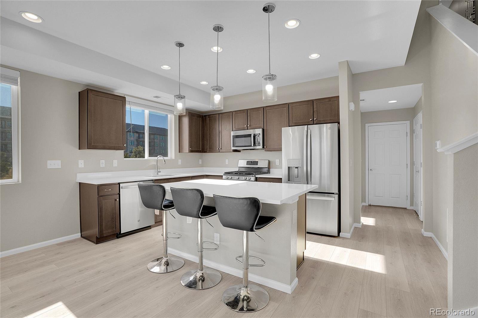 6419 North Dunkirk Street Denver, CO 80249 - Photo 11 of 31 a large kitchen with a table and chairs