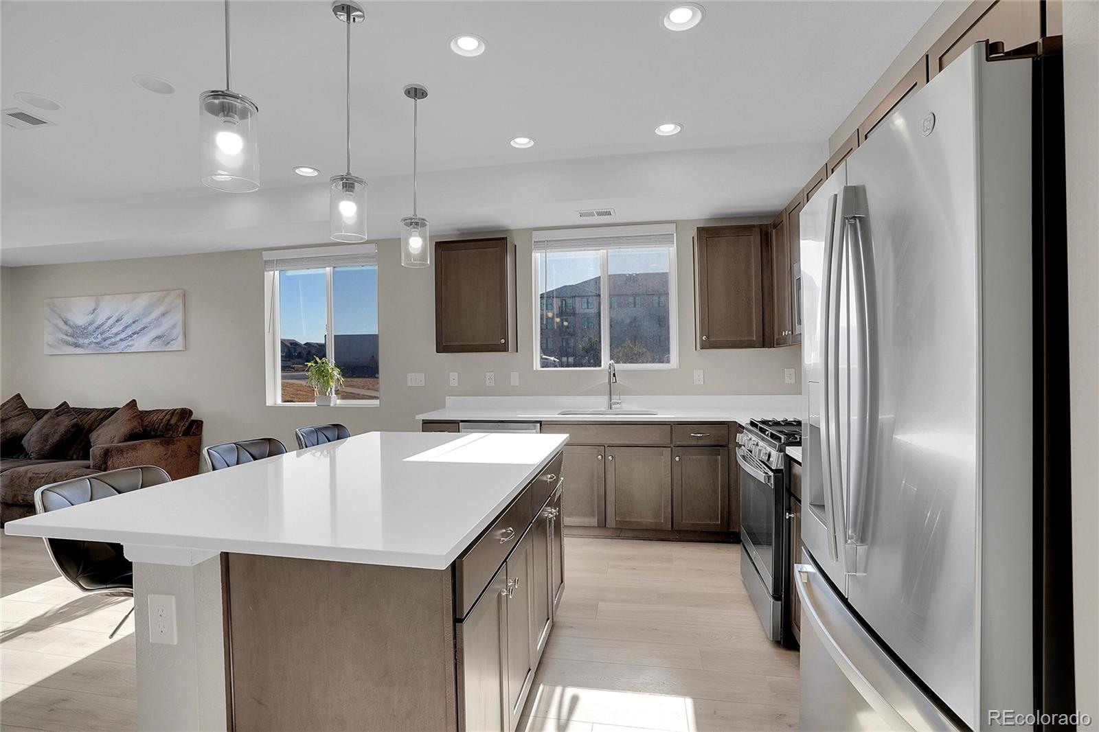6419 North Dunkirk Street Denver, CO 80249 - Photo 12 of 31 a kitchen with granite countertop a sink appliances and cabinets