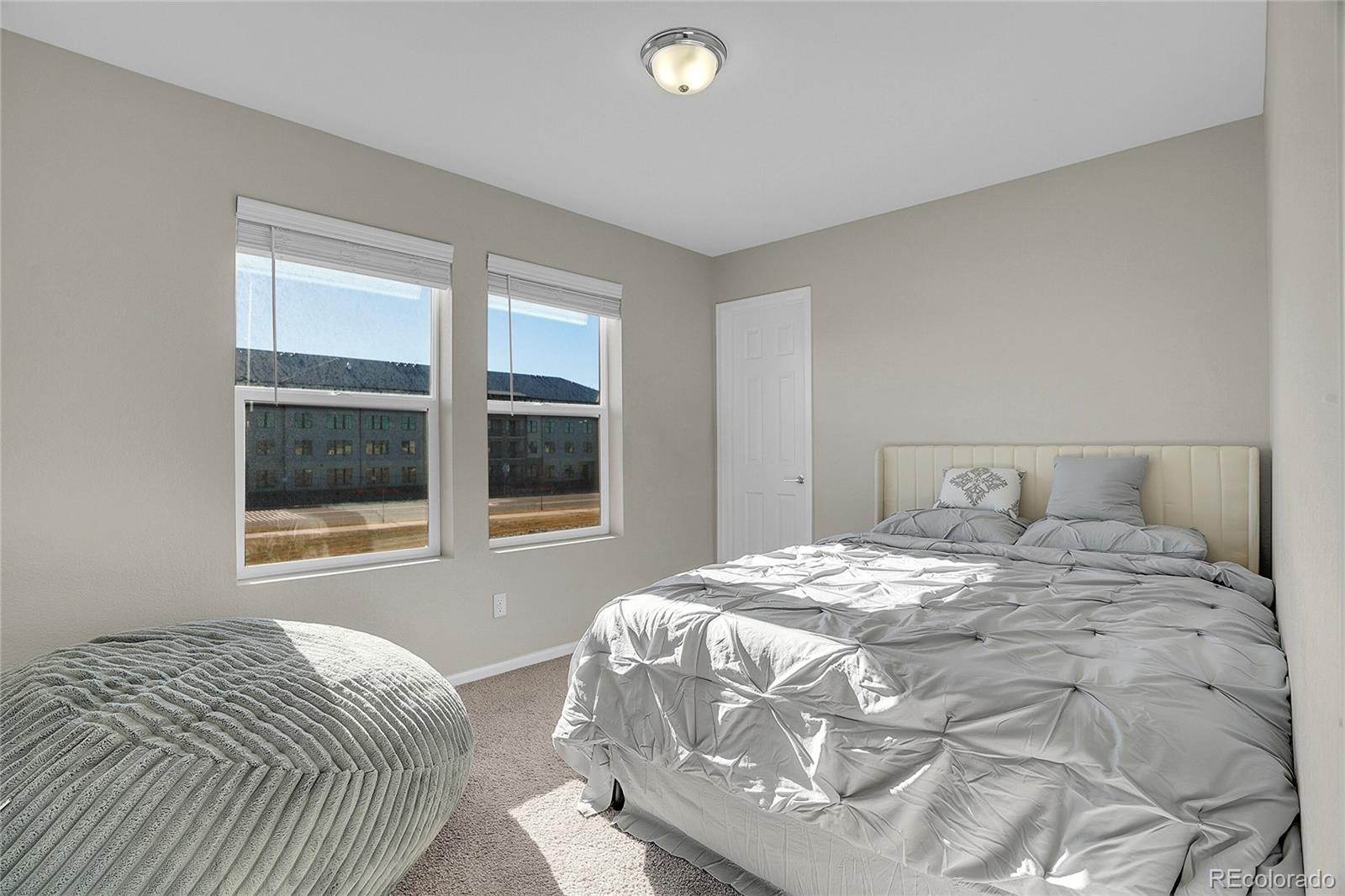 6419 North Dunkirk Street Denver, CO 80249 - Photo 18 of 31 a bedroom with a bed and window