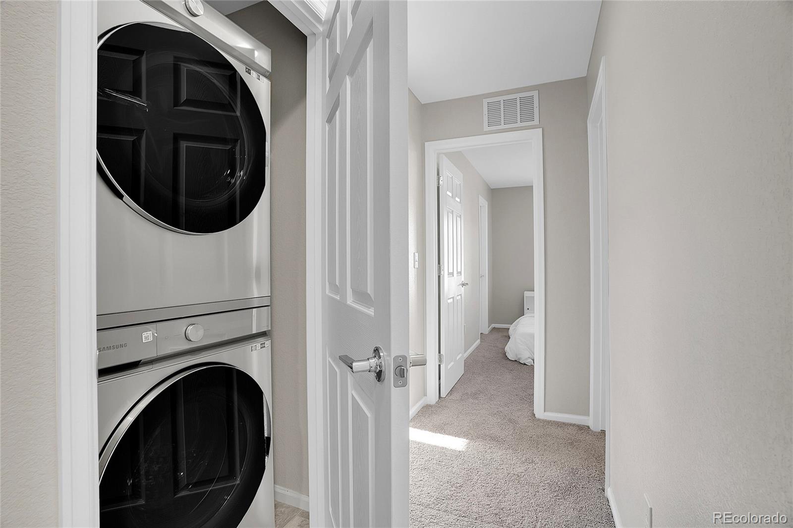 6419 North Dunkirk Street Denver, CO 80249 - Photo 20 of 31 a view of a hallway with washer and dryer