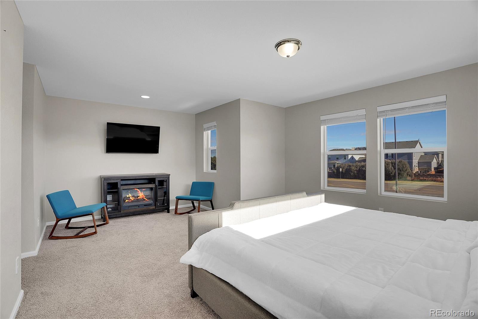 6419 North Dunkirk Street Denver, CO 80249 - Photo 24 of 31 a bedroom with furniture and a flat screen tv