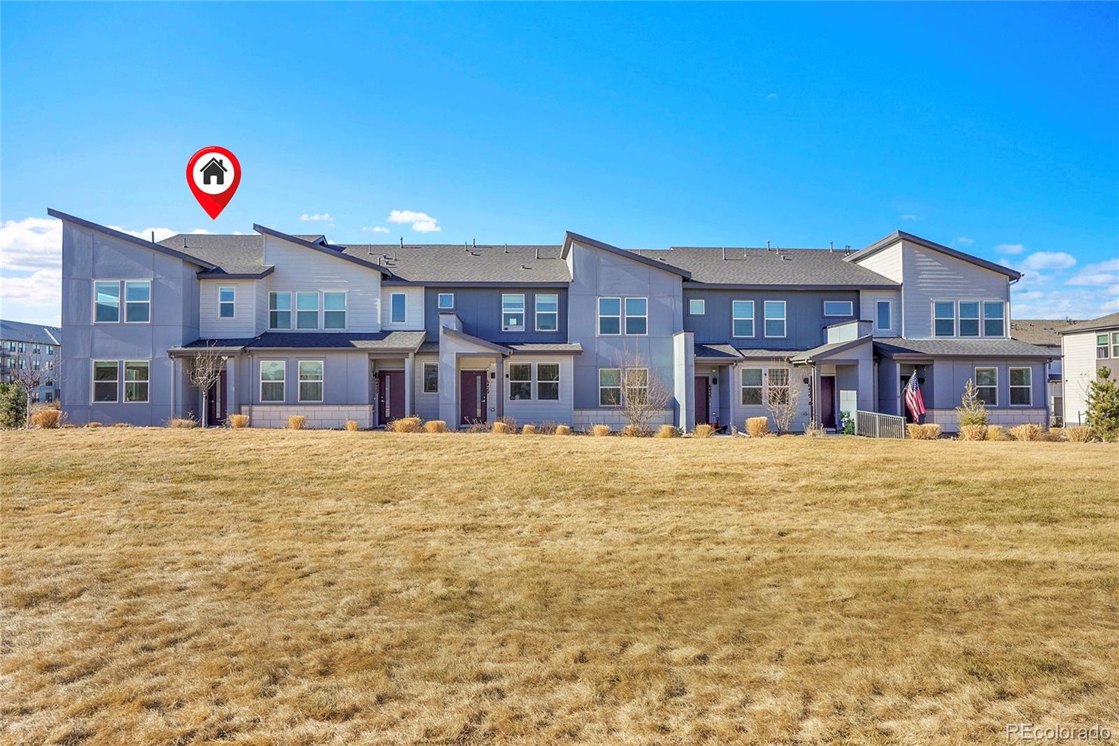 6419 North Dunkirk Street Denver, CO 80249 - Photo 3 of 31 a front view of a building with a yard