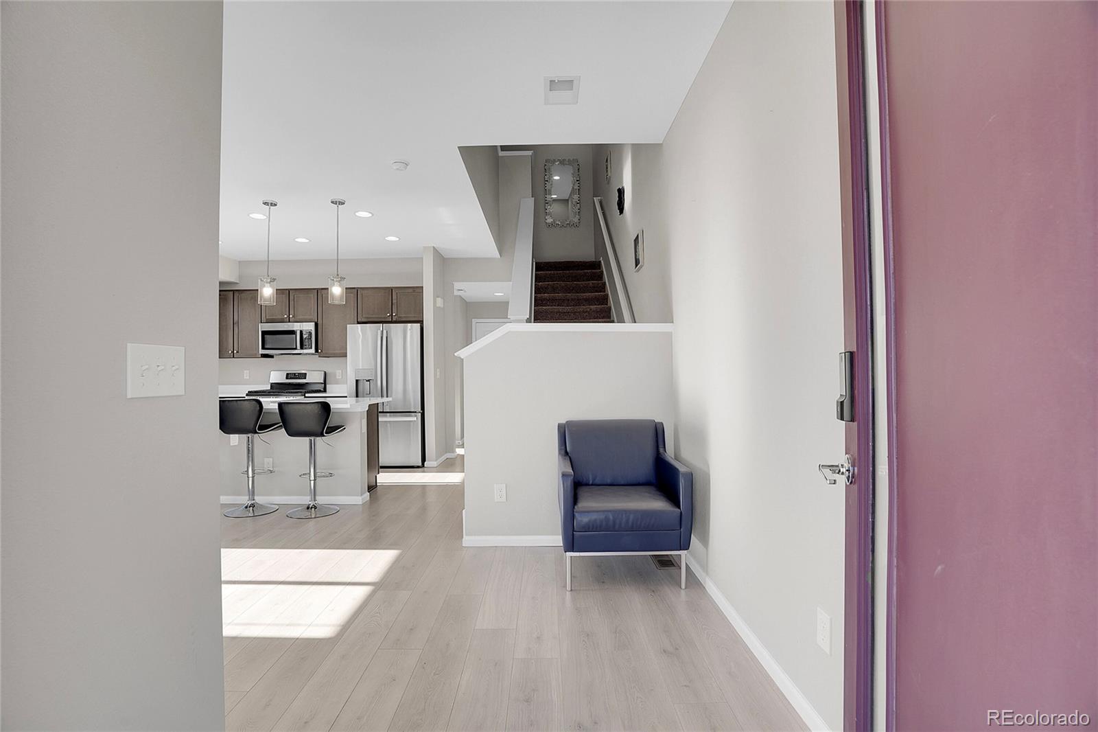 6419 North Dunkirk Street Denver, CO 80249 - Photo 4 of 31 a living room with furniture and a potted plant