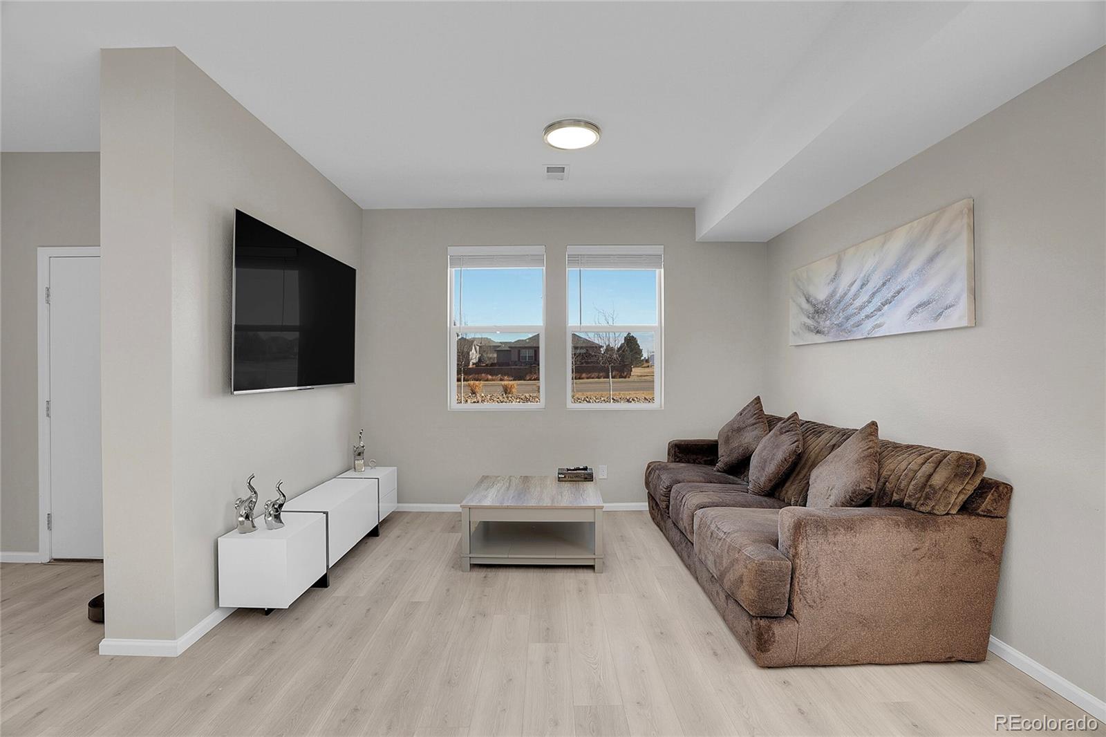 6419 North Dunkirk Street Denver, CO 80249 - Photo 7 of 31 a living room with furniture and a flat screen tv