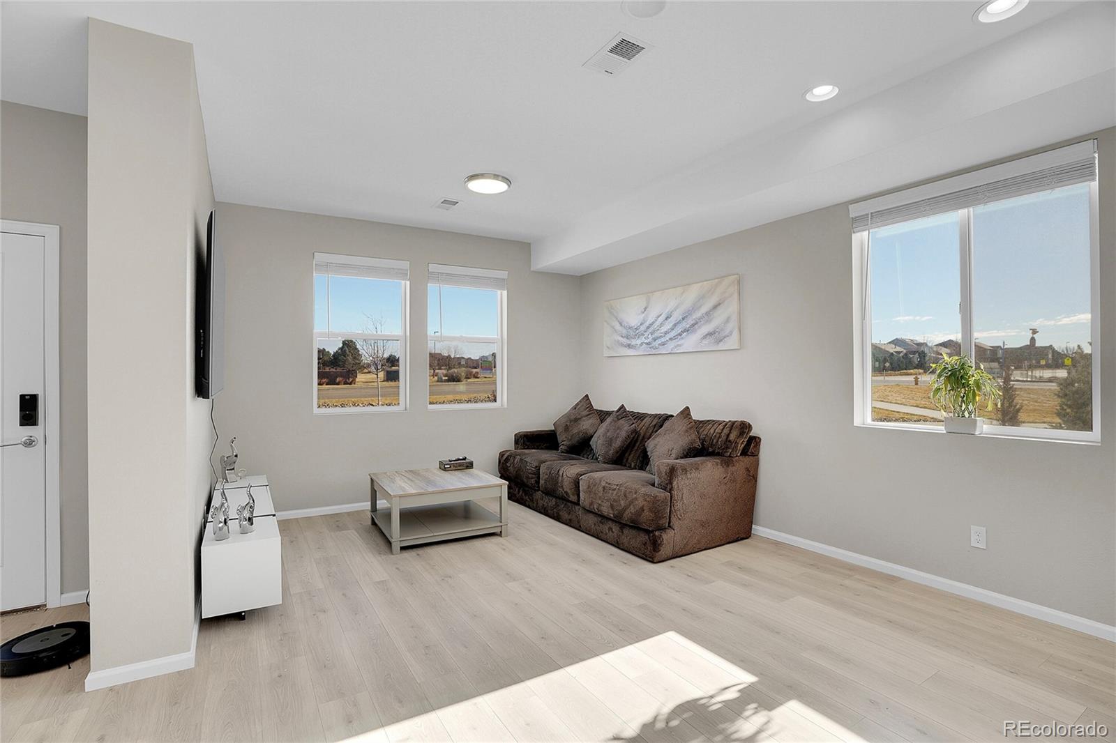 6419 North Dunkirk Street Denver, CO 80249 - Photo 8 of 31 a living room with furniture and a window