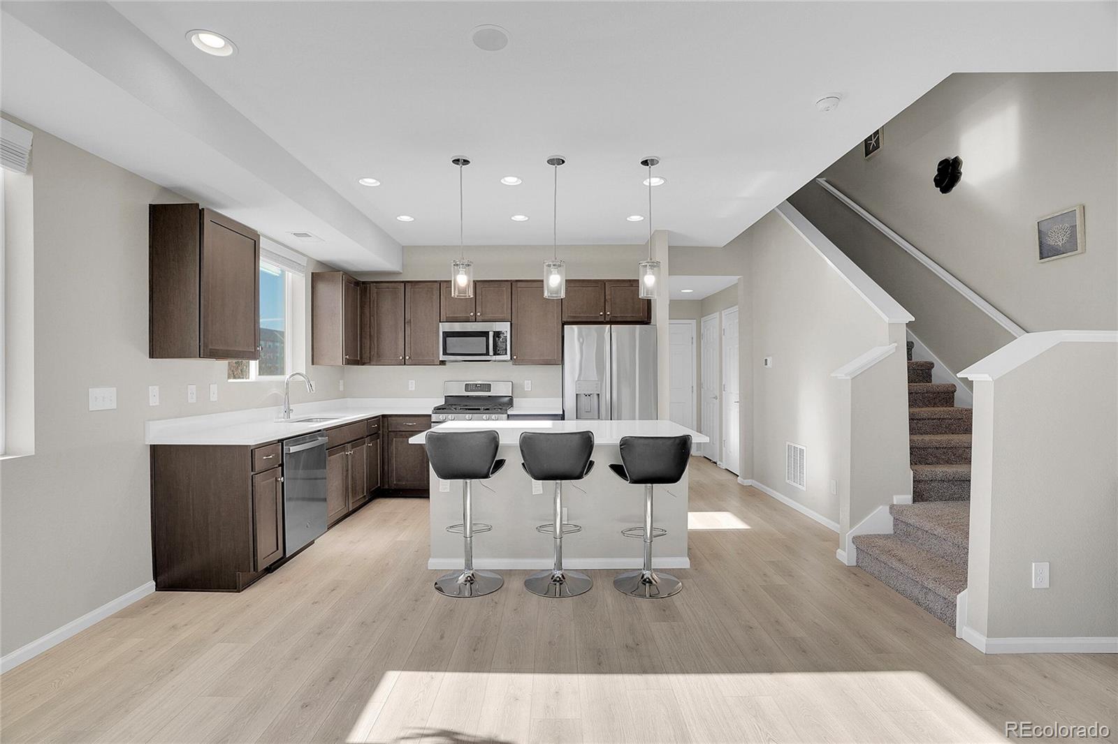 6419 North Dunkirk Street Denver, CO 80249 - Photo 10 of 31 a kitchen with a cabinets and counter space