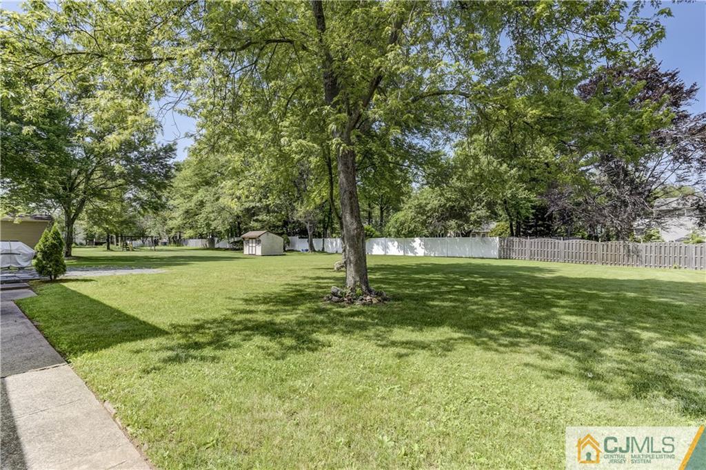 275 Plainfield Road Edison, NJ 08820 - Photo 22 of 22 a view of outdoor space with deck and trees