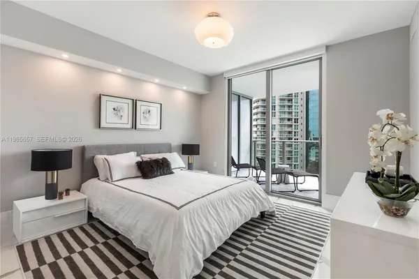 a bedroom with a large bed and a flat screen tv