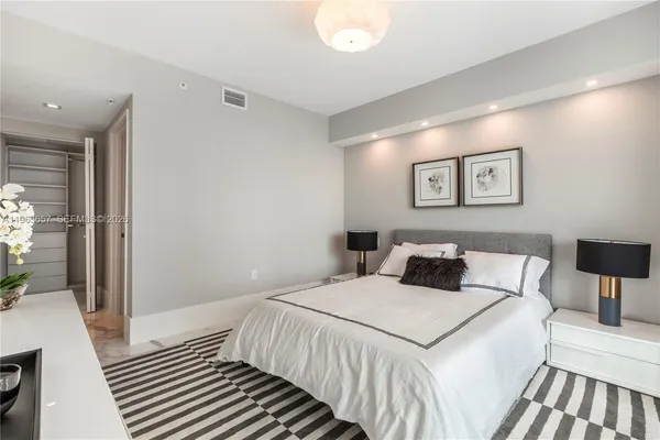 a bedroom with a bed and a lamp on table