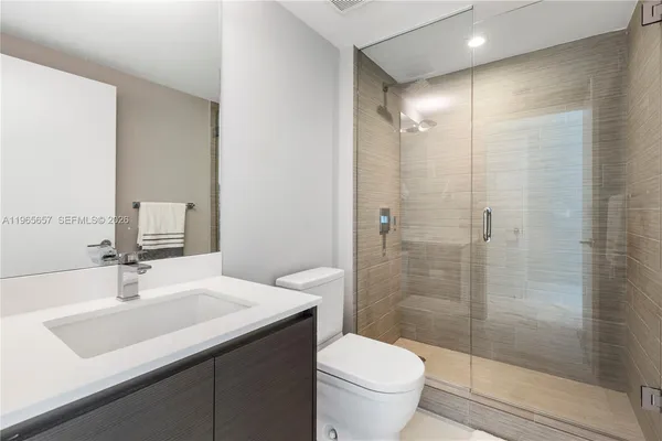 a bathroom with a sink toilet and shower