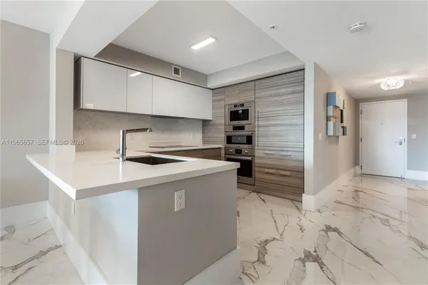 a kitchen with a stove and a refrigerator