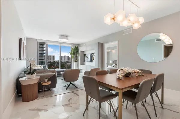 a dining room with furniture a mirror and wooden floor