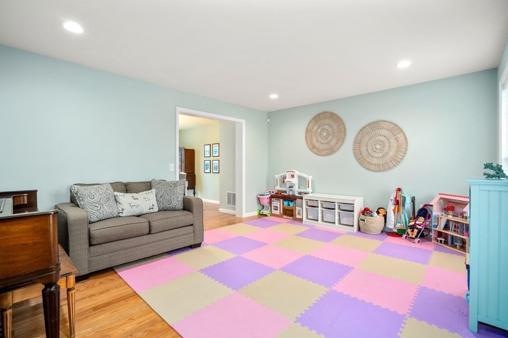 106 Colonial Road Marshfield, MA 02050 - Photo 13 of 42 a living room with furniture and a clock