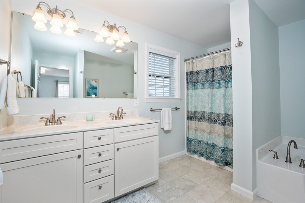 106 Colonial Road Marshfield, MA 02050 - Photo 17 of 42 a bathroom with a sink a toilet a mirror and shower