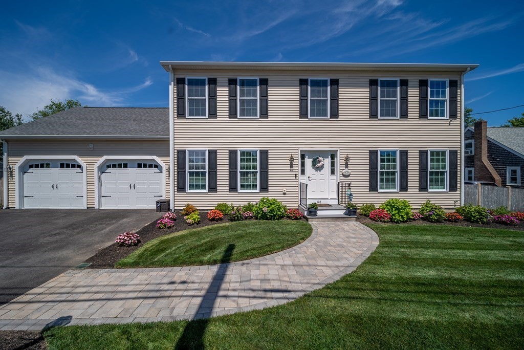 106 Colonial Road Marshfield, MA 02050 - Photo 2 of 42 a front view of a house with a yard and garage