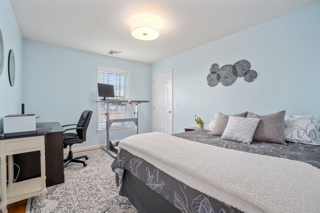 106 Colonial Road Marshfield, MA 02050 - Photo 21 of 42 a bedroom with a bed a desk and chair