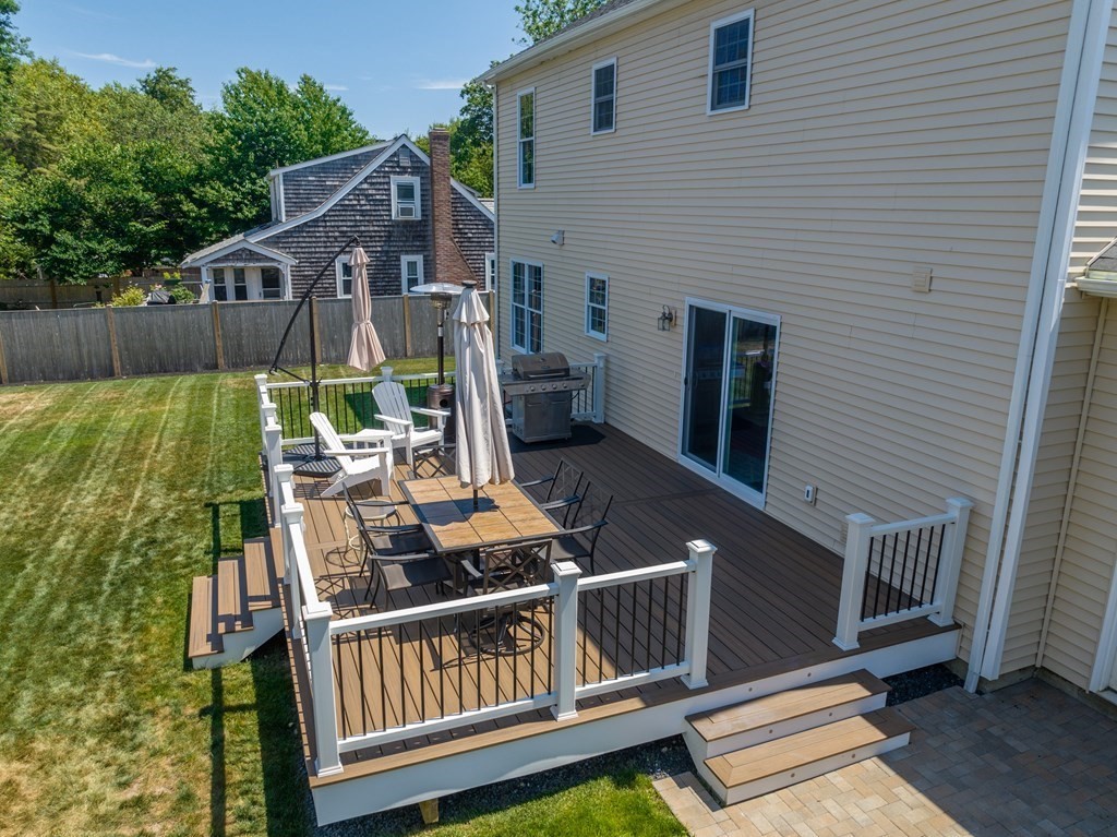 106 Colonial Road Marshfield, MA 02050 - Photo 27 of 42 a view of a deck with two chairs and a table with wooden floor