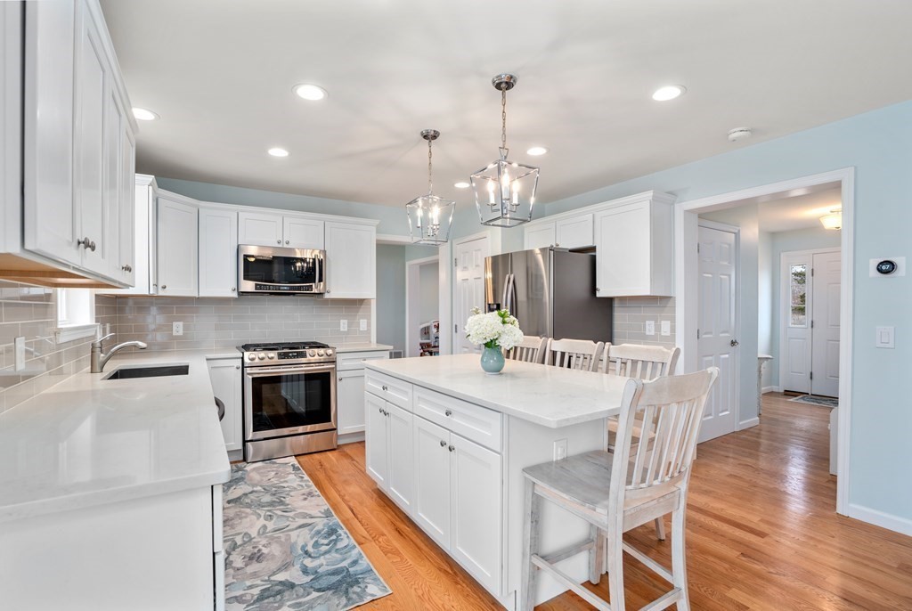 106 Colonial Road Marshfield, MA 02050 - Photo 3 of 42 a large white kitchen with lots of counter space and stainless steel appliances