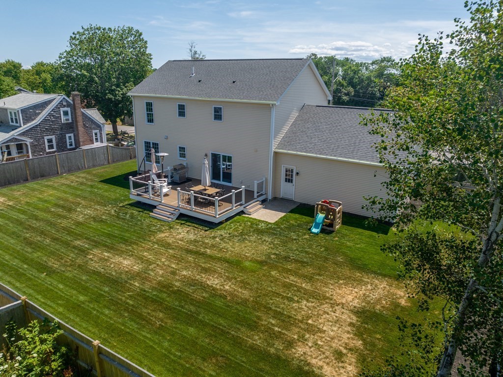 106 Colonial Road Marshfield, MA 02050 - Photo 32 of 42 a backyard of a house with table and chairs