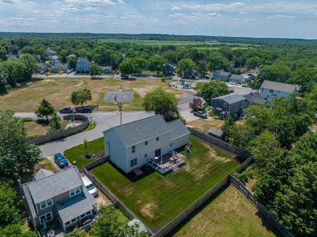 106 Colonial Road Marshfield, MA 02050 - Photo 33 of 42 an aerial view of a house with a garden and lake view