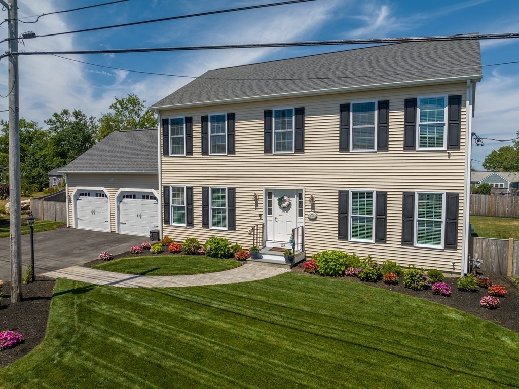 106 Colonial Road Marshfield, MA 02050 - Photo 36 of 42 a front view of a house with a garden and yard