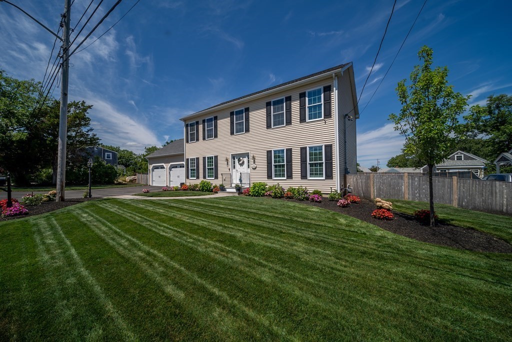 106 Colonial Road Marshfield, MA 02050 - Photo 38 of 42 a front view of a house with a yard table and chairs