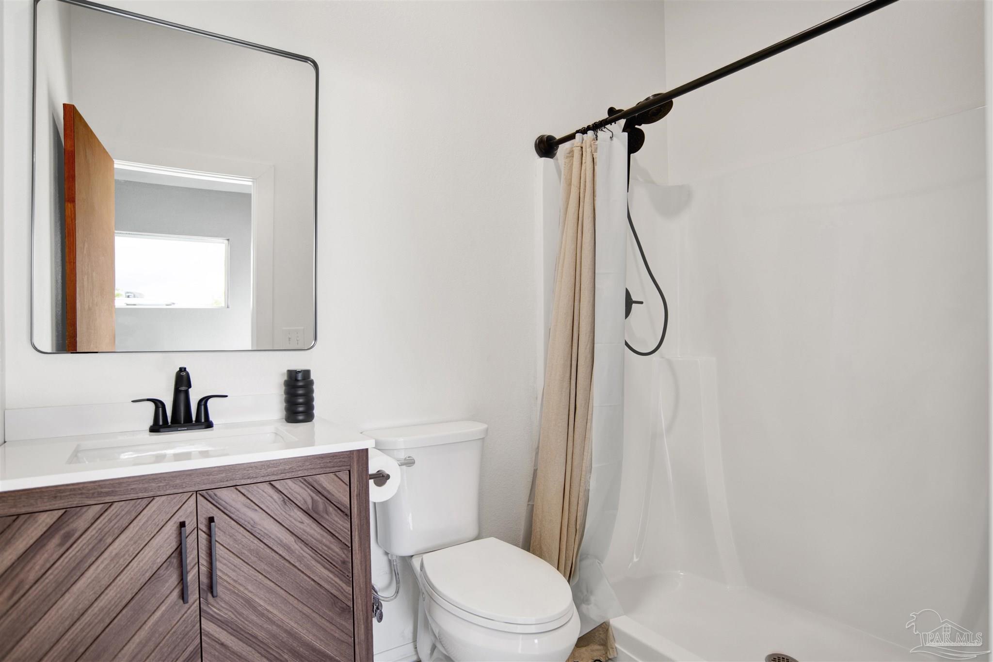 2810 Wallace Lake Road Pace, FL 32571 - Photo 53 of 65 a bathroom with a sink a toilet and shower