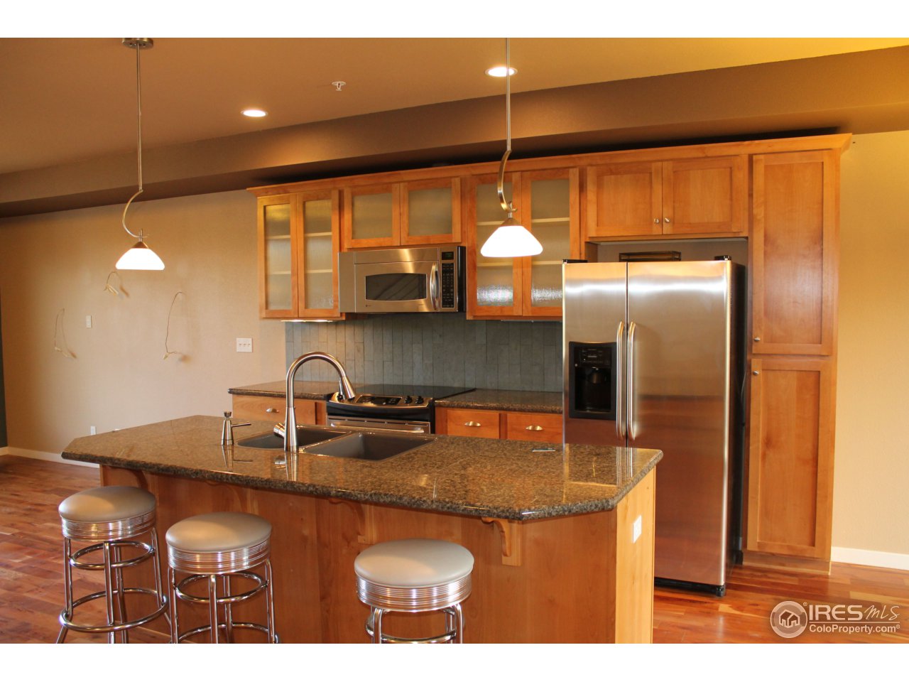 325 Cherry Street, Unit 210 Fort Collins, CO 80521 - Photo 2 of 13 a kitchen with stainless steel appliances granite countertop a sink a stove and a refrigerator