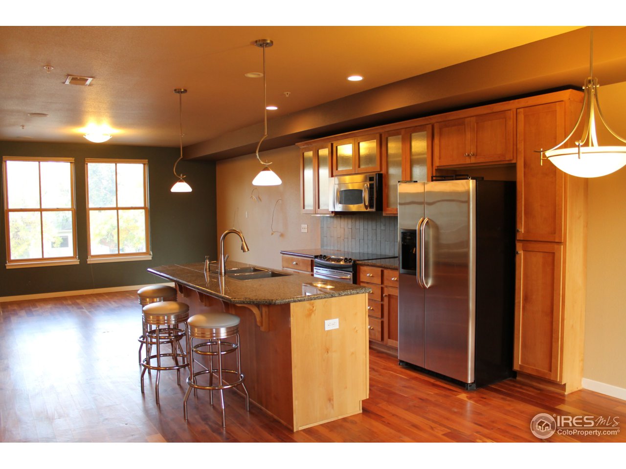 325 Cherry Street, Unit 210 Fort Collins, CO 80521 - Photo 6 of 13 a kitchen with stainless steel appliances granite countertop a refrigerator and a stove