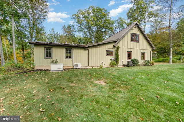 a view of a house with yard and tree s