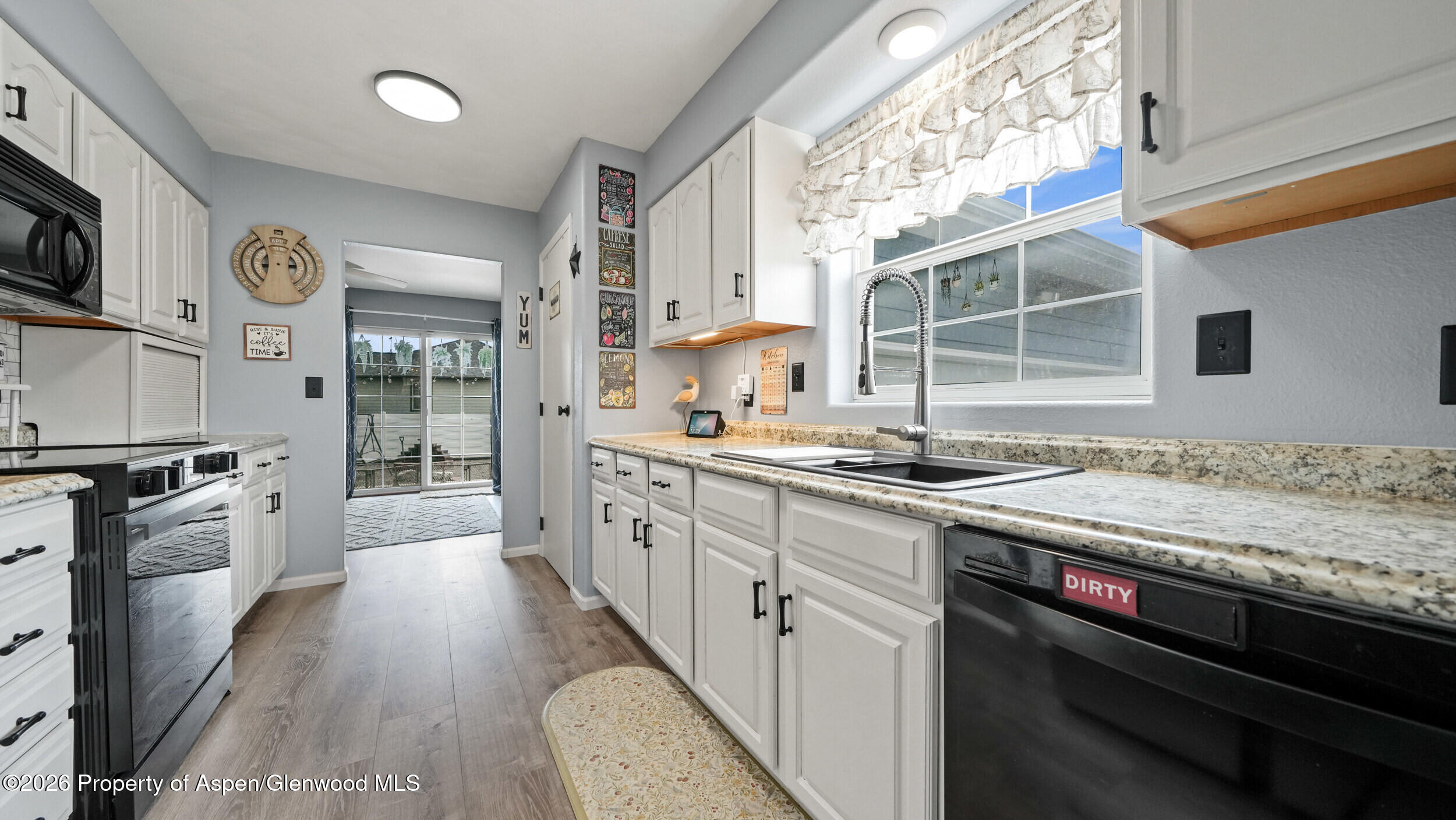 2750 East Avenue Rifle, CO 81650 - Photo 12 of 35 a large kitchen with stainless steel appliances granite countertop a stove and a sink