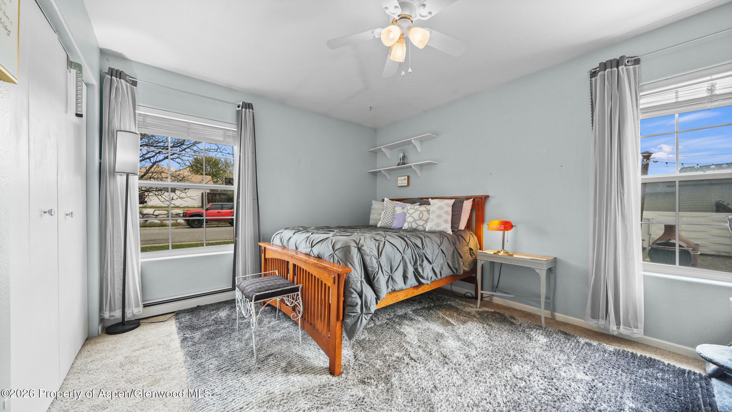 2750 East Avenue Rifle, CO 81650 - Photo 16 of 35 a bed room with a bed and a painting on the wall