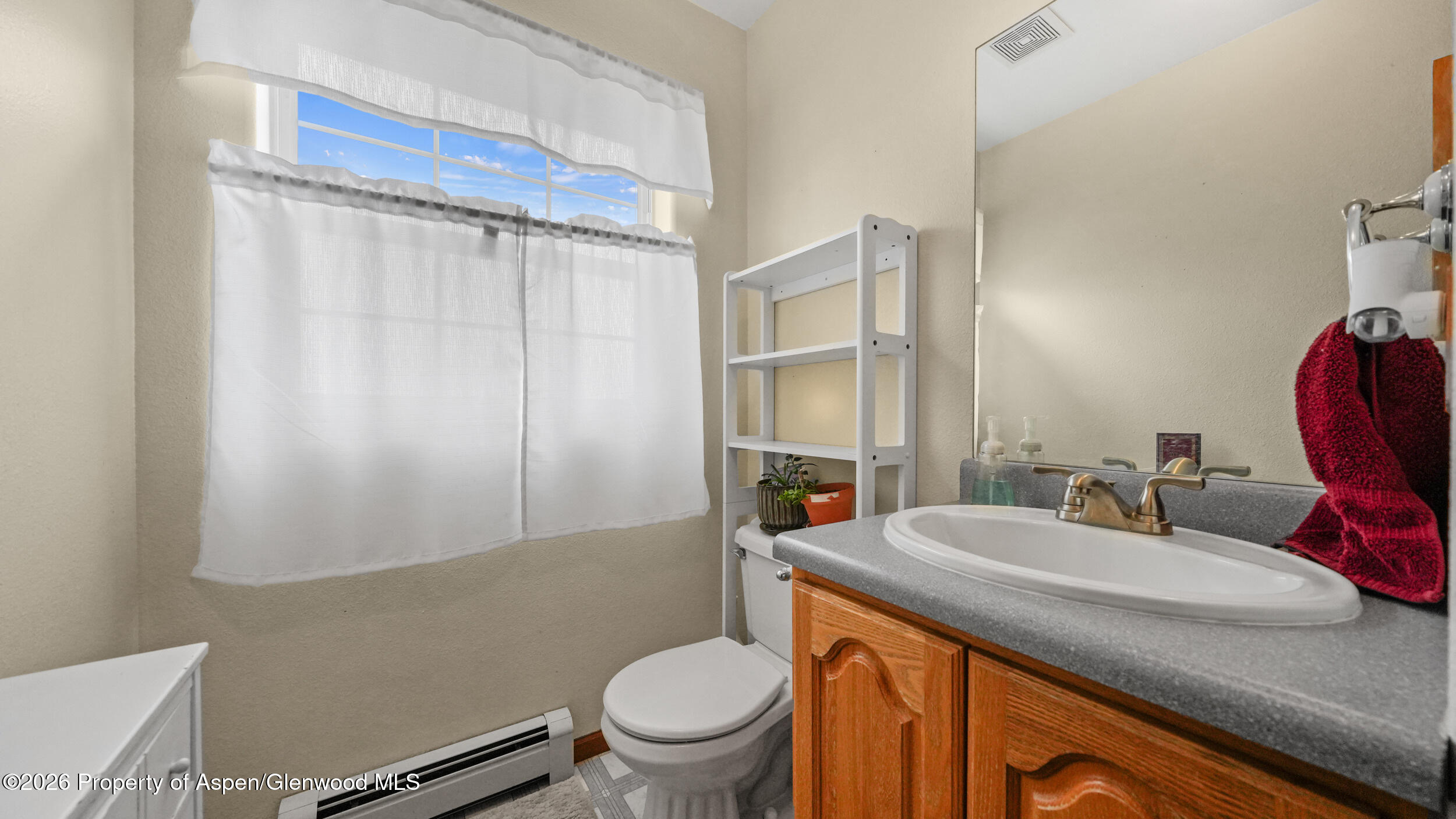 2750 East Avenue Rifle, CO 81650 - Photo 17 of 35 a bathroom with a granite countertop sink toilet and mirror