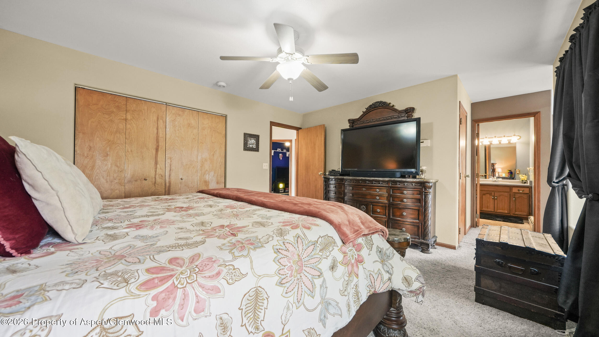 2750 East Avenue Rifle, CO 81650 - Photo 20 of 35 a bedroom with a bed and a flat screen tv