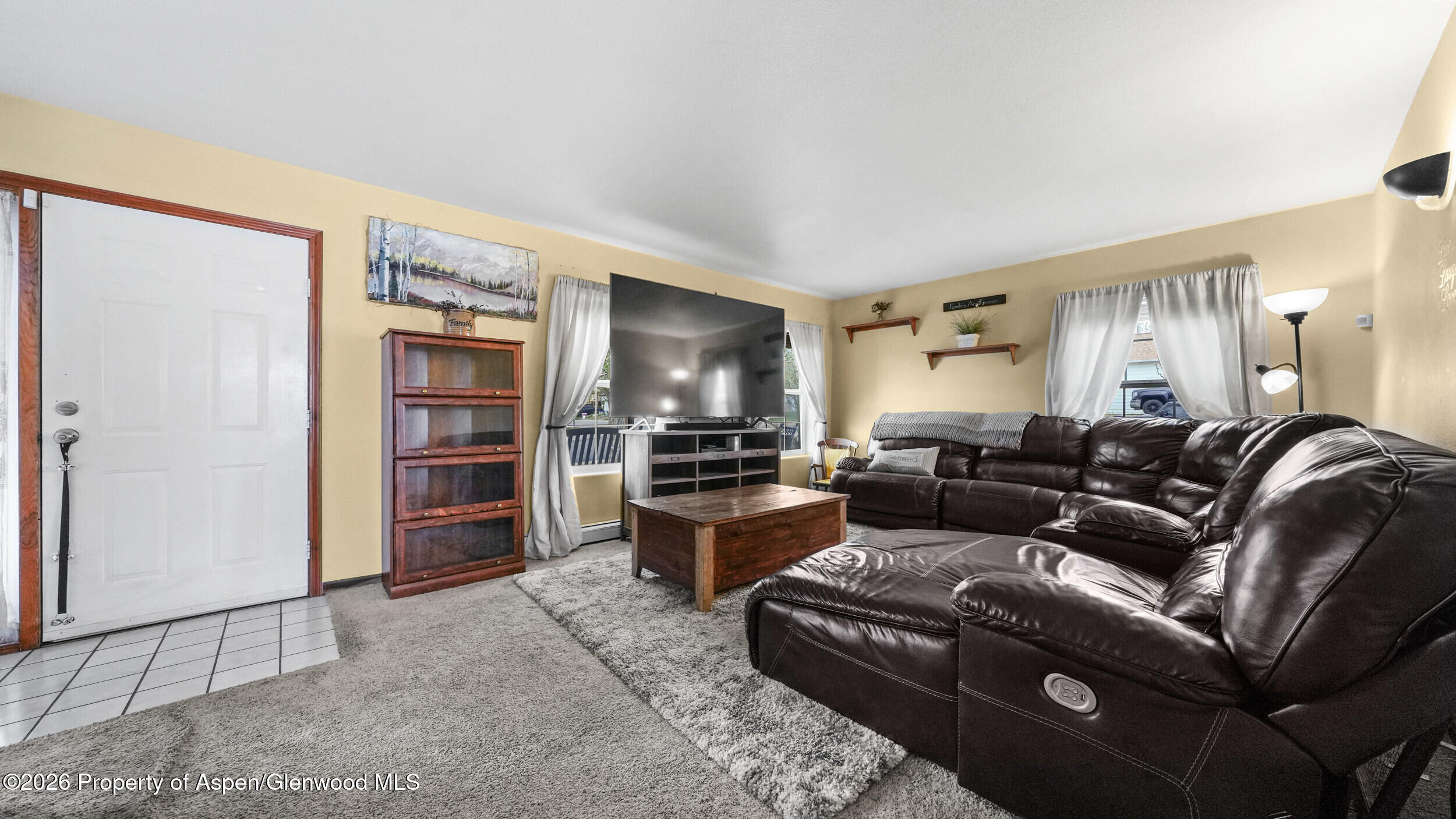2750 East Avenue Rifle, CO 81650 - Photo 6 of 35 a living room with furniture and a flat screen tv