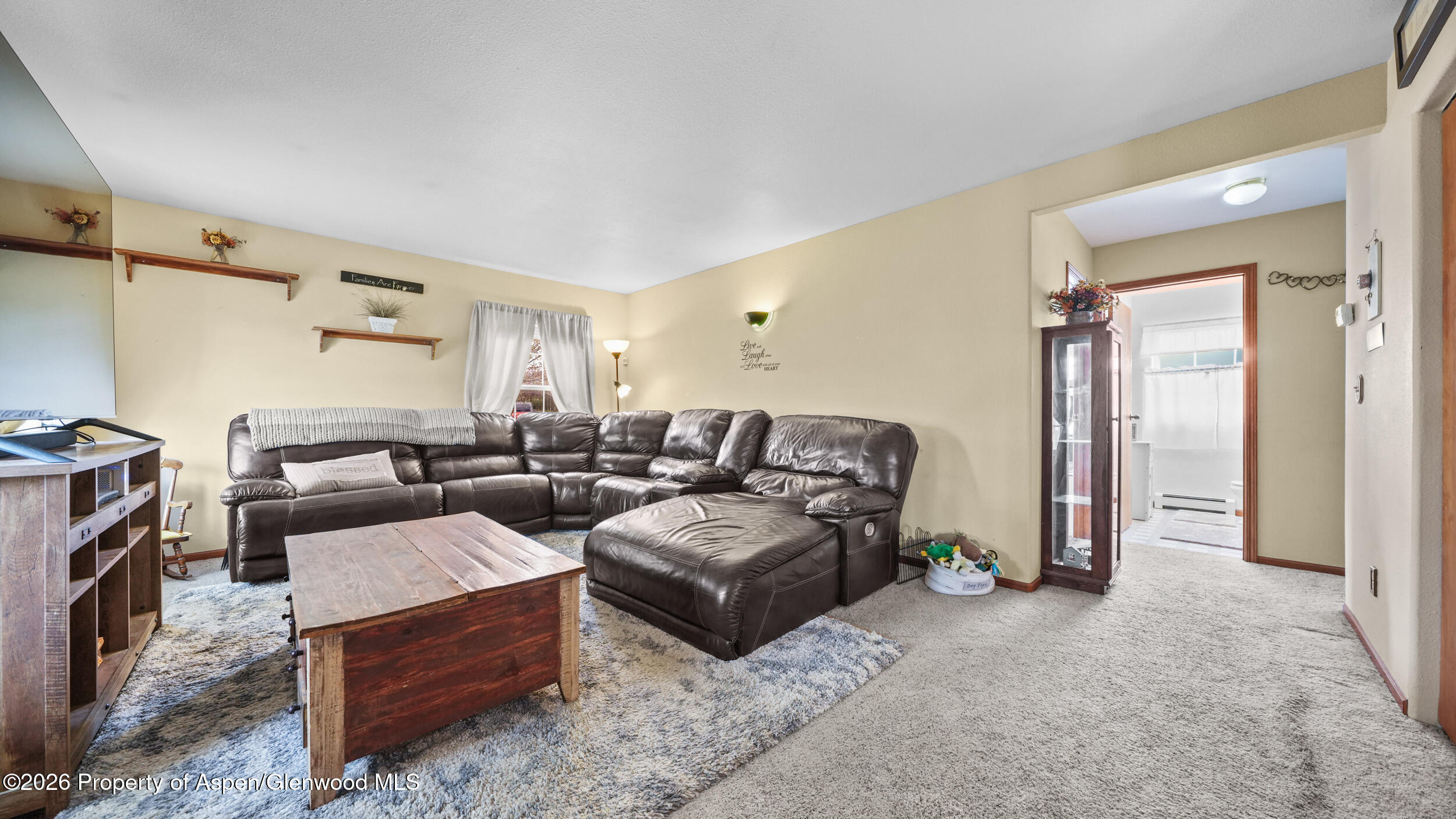 2750 East Avenue Rifle, CO 81650 - Photo 7 of 35 a living room with furniture and a fireplace