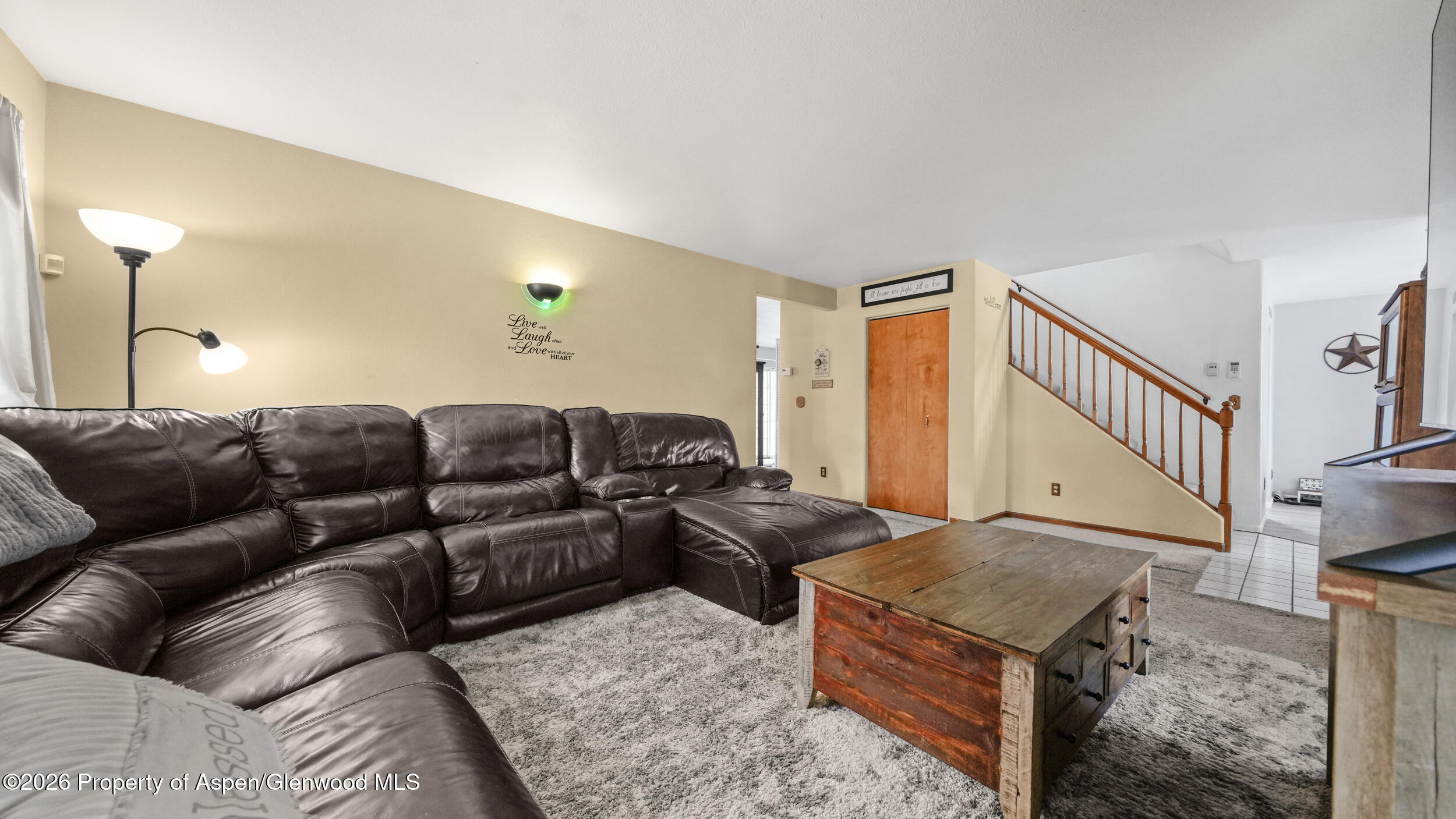 2750 East Avenue Rifle, CO 81650 - Photo 8 of 35 a living room with furniture and a lamp